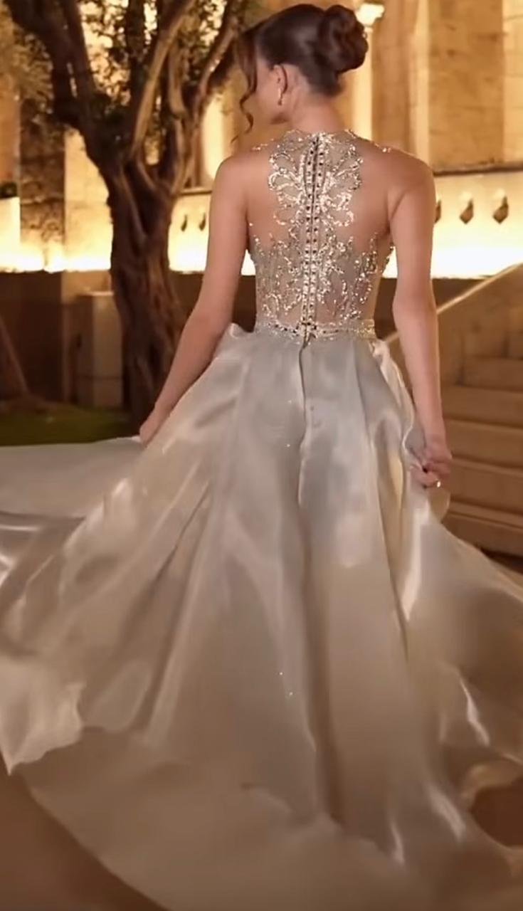 Bride from behind in a hand-beaded ivory couture gown with intricate crystal back detail by Designer DK for Shaddai Designs